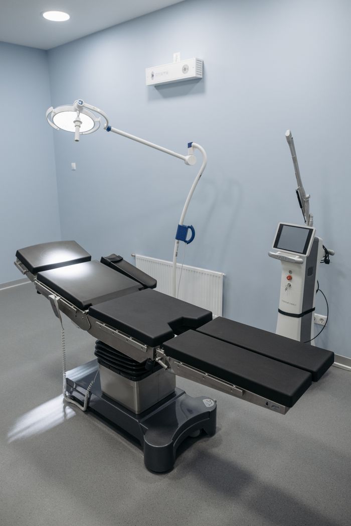 State-of-the-art operating room with surgical table and equipment, ideal for medical facilities.